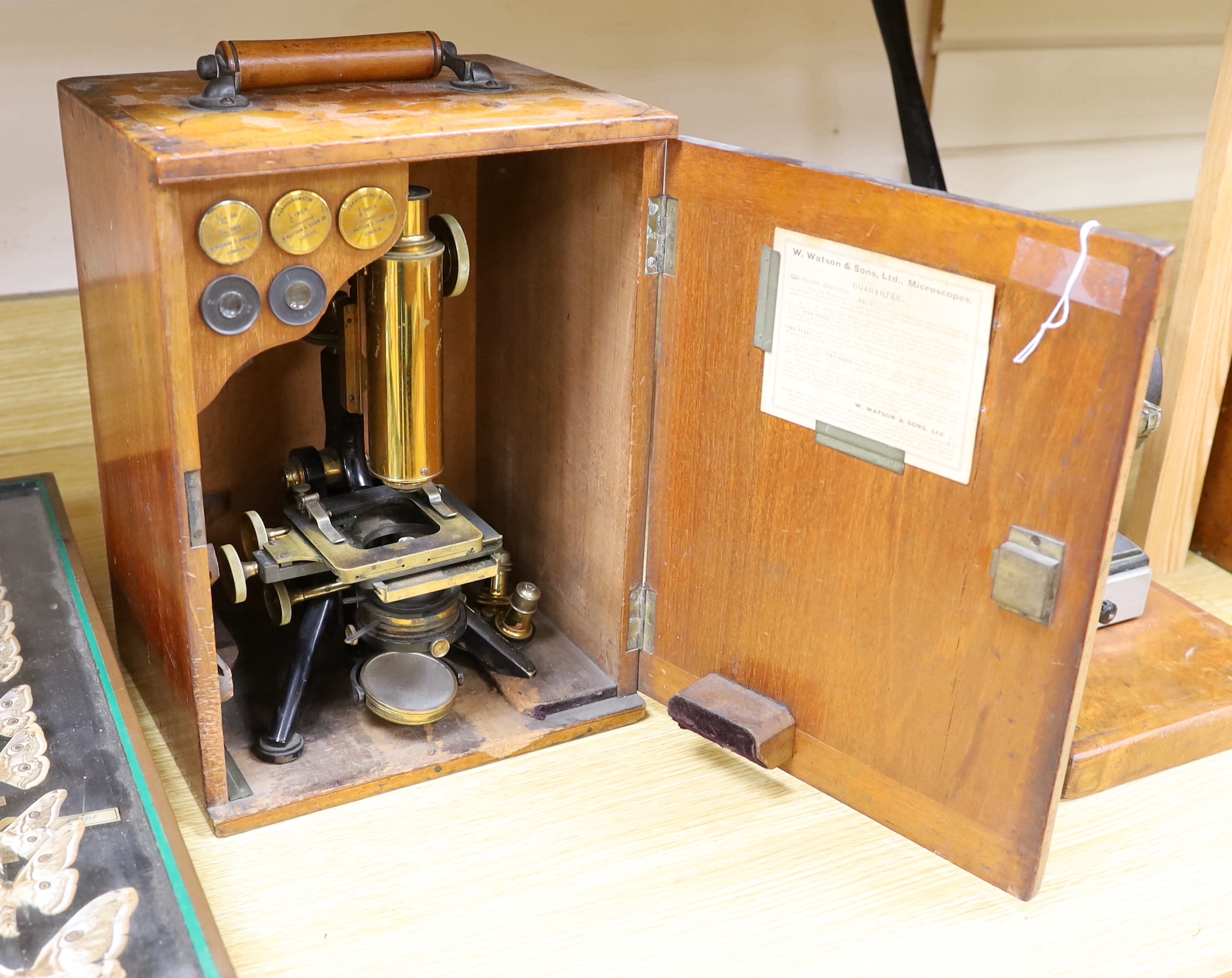 A Victorian monocular brass and black enamel microscope by W. Watson & Sons, High Holborn, in a mahogany carrying case, Serial no.19919, with a number of alternative lens of different magnification, case 34.5cm high